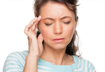 Woman rubbing head in pain
