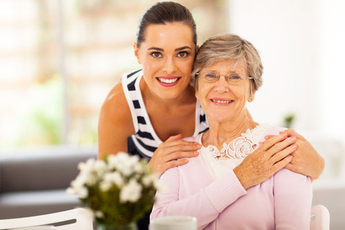 Woman and elderly woman smiling together