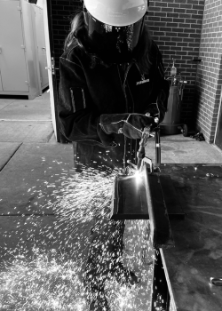 SuperFlash Sales Representative Brittany Fichter showing off her welding skills